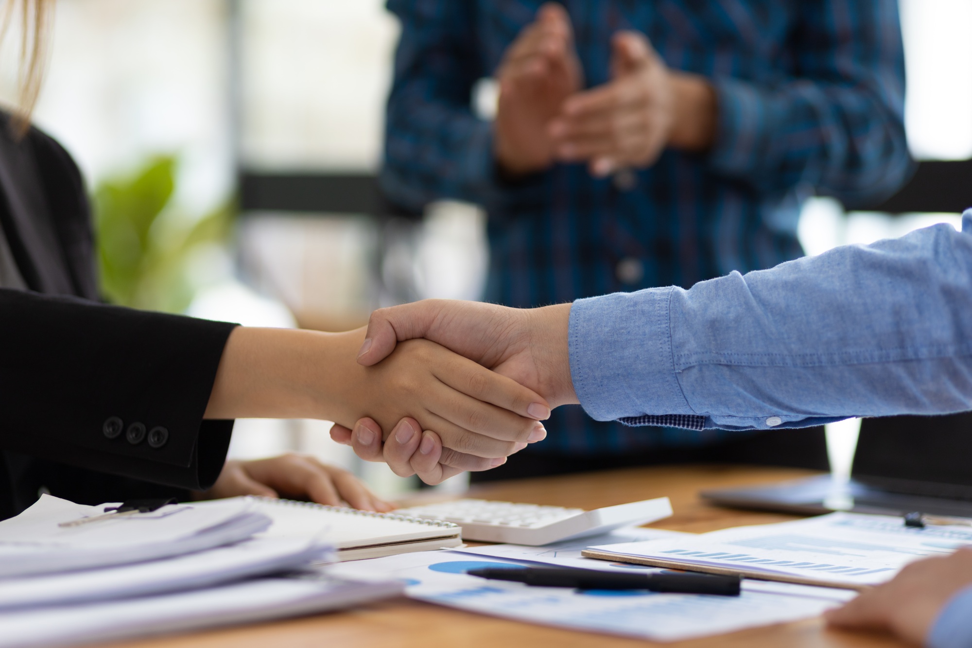 Handshake of business partners at a meeting.